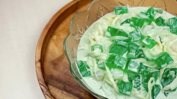 Buko Pandan Salad is made with gulaman cubes, tropical palm fruits, and shredded young coconut in sweetened cream. 